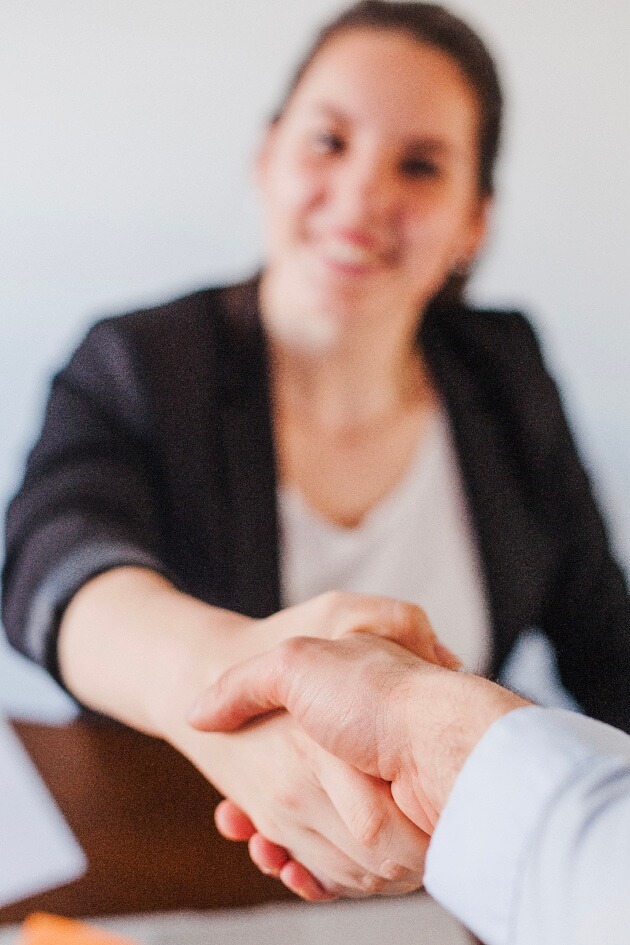 //globallinkrecruitment.com/wp-content/uploads/2025/02/office-worker-shaking-hands-2.jpg